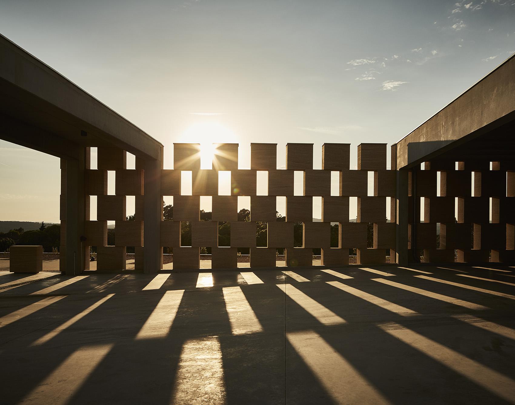 Timeless travertine and bronze facade at golden hour